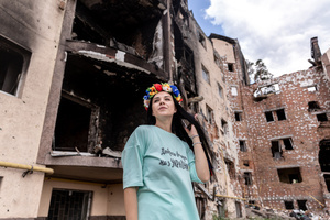 Nadia poses for a photo in a traditional Ukrainian flower crown in front a residential building destroyed by bombardment. Four months after Russia launched its invasion of Ukraine, fighting has moved from areas around the capital Kyiv to eastern regions. Just 25 kilometers from Kyiv, however, the town of Irpin still bears the scars of heavy fighting and shelling, which reduced many buildings to ruins.