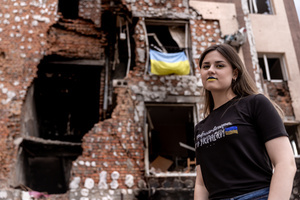 Evgeniya poses for a photog with Ukrainian flag colours make-up in front a residential building destroyed by bombardment. Four months after Russia launched its invasion of Ukraine, fighting has moved from areas around the capital Kyiv to eastern regions. Just 25 kilometers from Kyiv, however, the town of Irpin still bears the scars of heavy fighting and shelling, which reduced many buildings to ruins.