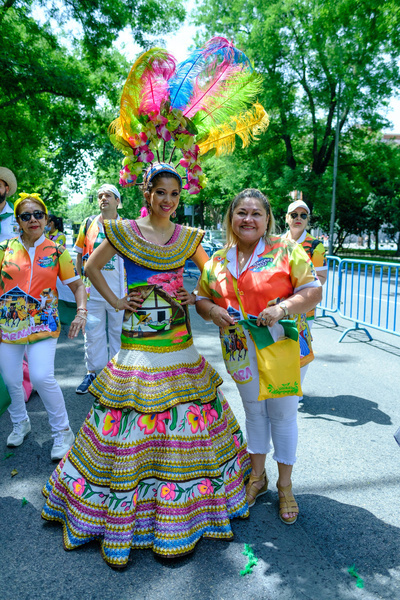 Women of Bolivian origin pose for a photo as they take part during the carnival parade of the Flor del Patujú festival at the Paseo del Prado in Madrid.