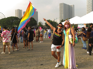 LGBTQ couple pose with a rainbow flag at CCP Open Grounds during the Metro Manila Pride March. LGBTQ (Lesbian, Gay, Bisexual, Transgender and Queer) activists staged the annual Pride March and Festival at CCP Open Grounds in Pasay City.