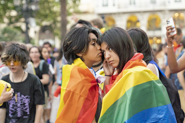 Two people seen with Pride flag, during the LGTBIQ+ demonstration in favor of rights for sexual, gender and family diversity.