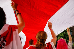 People hold a big white-red-white flag above their heads during the March of dignity dedicated to the 2nd anniversary of the beginning of the protests in Belarus. Belarusian diaspora around the world organized the International day of solidarity with Belarus, dedicated to the anniversary of the presidential elections in Belarus on August 9, 2020. After falsifying the election results and police brutality, hundreds of thousands of people in Belarus went to the street to show their peaceful pro-democracy protest. Repressions dedicated to the pre-election period and post-election period continued till now. Some people were forced to leave Belarus because of security reasons.