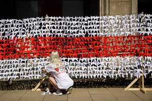 A young woman attaches a paper crane to an installation in front of the Belarusian youth hub at the beginning of the March of dignity dedicated to the 2nd anniversary of the beginning of the protests in Belarus. Belarusian diaspora around the world organized the International day of solidarity with Belarus, dedicated to the anniversary of the presidential elections in Belarus on August 9, 2020. After falsifying the election results and police brutality, hundreds of thousands of people in Belarus went to the street to show their peaceful pro-democracy protest. Repressions dedicated to the pre-election period and post-election period continued till now. Some people were forced to leave Belarus because of security reasons.