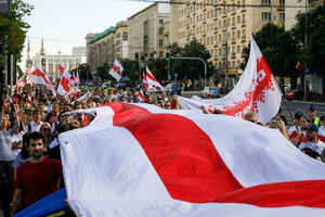 People held a big white-red-white flag while walking along the center of Warsaw during the March of dignity dedicated to the 2nd anniversary of the beginning of the protests in Belarus. Belarusian diaspora around the world organized the International day of solidarity with Belarus, dedicated to the anniversary of the presidential elections in Belarus on August 9, 2020. After falsifying the election results and police brutality, hundreds of thousands of people in Belarus went to the street to show their peaceful pro-democracy protest. Repressions dedicated to the pre-election period and post-election period continued till now. Some people were forced to leave Belarus because of security reasons.