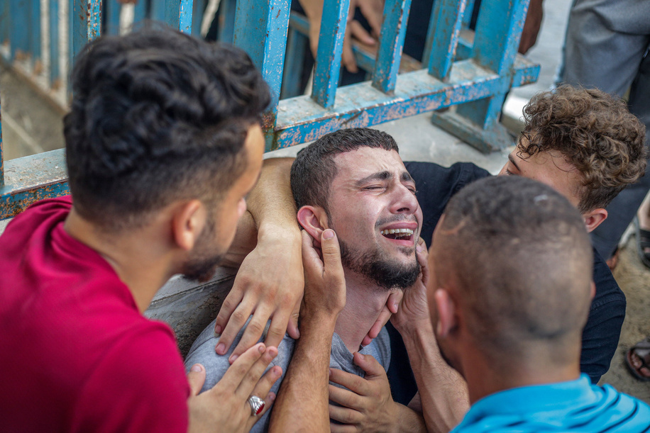 Palestinians mourn over the body of Tayseer al-Jabari in a hospital morgue. He was a commander in Saraya al-Quds, the military wing of Islamic Jihad, and was killed in an Israeli air strike. The senior commander of Islamic Jihad and a five-year-old girl were killed in an Israeli air strike. The Palestinian militant group said, 