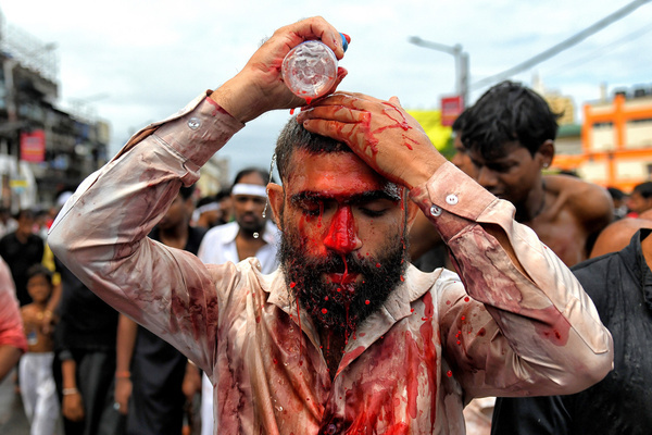 (EDITORS NOTE: Image contains graphic content.) A Shia Muslim devotee covers himself with blood after dangerously wounding himself with Swords while showing his grief during the Muharram procession of Kolkata. Muharram is the first month of the Islamic calendar & Ashura is the tenth day of the month of Muharram on which the commemoration of the martyrdom of Imam Hussain, the grandson of Prophet Muhammad (PBUH), during the battle of Karbala, is done. It is part of Mourning for Shia Muslims and a day of fasting for Sunni Muslims that is observed all over the World.