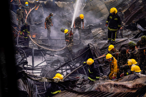 Firefighters along with the help of the Army and Police personnel douse a fire that broke out in a shoe factory caused by a short circuit at Balaju.