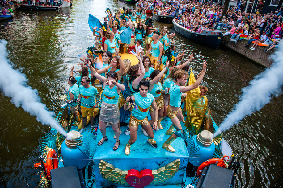 People are seen dancing in one of the boats. The Canal Parade is what Amsterdam Gay Pride is famous for. It's the crown on their two weeks lasting festival that features more than 200 events. The boats start at the Scheepvaart museum at the eastern part of the city center moving towards the Amstel river. The floats continue from there taking the Prinsengracht towards the Westerdok. The Canal Parade starts around noon and takes all afternoon. Around 80 boats of different organizations and non-profit organizations participate in the event.