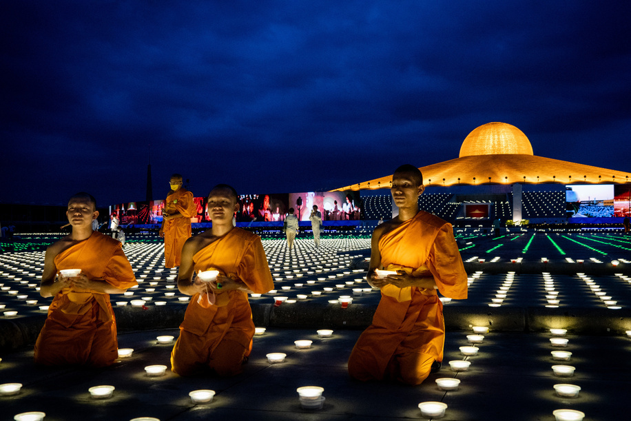 Monks hold LED torches during a mass meditation ceremony to promote world peace at Wat Phra Dhammakaya. Wat Phra Dhammakaya commemorates the World Fellowship of Buddhist Youth (WFBY) 