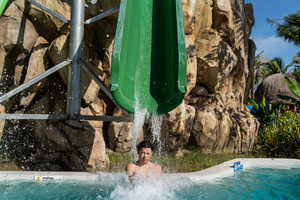 A water park enthusiast braces for landing in a pool at Andamanda Waterpark in Phuket.