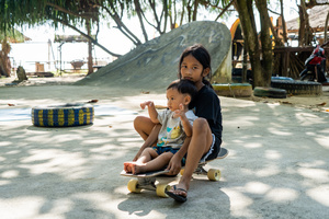 Kids ride on a skateboard at a skatepark in Khao Lak.