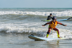 A kid surfs in Khao Lak, the only place known for surfing in Thailand. To grow tourism in underserved areas of Thailand, the country's marketing agency, the Tourism Authority of Thailand (TAT), has launched campaigns to promote international tourism to the south as a part of its "Amazing New Chapters" campaign. This specific part of the campaign targets Phuket, Phangan, and Khao Lak, an area known to be the only place to go surfing in Thailand.