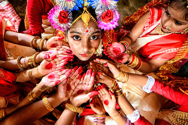 Young girls pose for a photo during the Kumari Puja Ritual on the 9th day of the Durga puja festival at a Pandal (Temporary place for worship) in Kolkata. Kumari Puja is an Indian Hindu tradition mainly celebrated during the Durga Puja following the Hindu Calendar. The philosophical basis of Kumari Puja is to establish the value of women. Devotees believe it will overcome all barriers and dangers for the young girls in the coming future, and also, young girls will be empowered to handle any stress and obstruction in their forthcoming life.