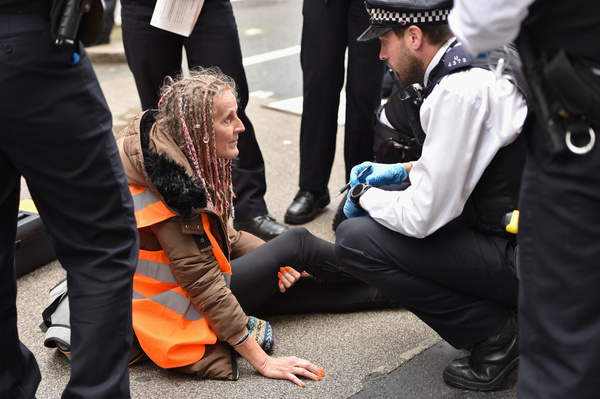 A protester glued herself to the street in Westminster during the demonstration. Climate activists group Just Stop Oil blocked the roads around Millbank and Horseferry Road on the 5th day of Occupy Westminster action, demanding to halt all future licensing and consents for the exploration, development and production of fossil fuels in the UK.