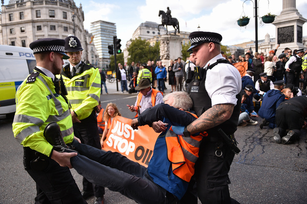 An activist is being arrested during the demonstration at Trafalgar Square. Climate activists group Just Stop Oil blocked the roads around Trafalgar Square on the 6th day of Occupy Westminster action, demanding to halt all future licensing and consents for the exploration, development and production of fossil fuels in the UK.