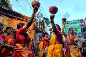 Women dressed in traditional Bengali dresses perform dhunuchi dance during the immersion procession at Bagbazar. Durga Puja, an annual festival that marks victory of good over evil is celebrated by Hindus all over India & abroad. It is an occasion of great enthusiasm and festivity for the Hindus. On the last day, the day of Bhashan or Vijoya Dashami images and idols are immersed in water.