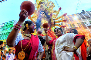 Women dressed in traditional Bengali dresses perform dhunuchi dance during the immersion procession at Bagbazar. Durga Puja, an annual festival that marks victory of good over evil is celebrated by Hindus all over India & abroad. It is an occasion of great enthusiasm and festivity for the Hindus. On the last day, the day of Bhashan or Vijoya Dashami images and idols are immersed in water.
