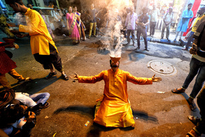 A Hindu devotee performs dhunuchi dance on the occasion of Durga Puja immersion at Kolkata. Durga Puja, an annual festival that marks victory of good over evil is celebrated by Hindus all over India & abroad. It is an occasion of great enthusiasm and festivity for the Hindus. On the last day, the day of Bhashan or Vijoya Dashami images and idols are immersed in water.