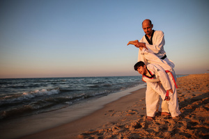 Palestinian youths play and practice taekwondo on the Mediterranean beach during sunset in Khan Yunis, southern Gaza Strip. The "Funoon" taekwondo team trains taekwondo at the Mediterranean beach at sunset, as part of a training program organized by the trainers in the team, as they allocate a day of training on the seashore of Khan Yunis, southern Gaza Strip.
