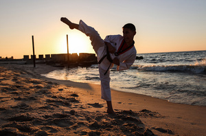A Palestinian youth shows his skills as he practices taekwondo on the Mediterranean beach during sunset in Khan Yunis, southern Gaza Strip. The "Funoon" taekwondo team trains taekwondo at the Mediterranean beach at sunset, as part of a training program organized by the trainers in the team, as they allocate a day of training on the seashore of Khan Yunis, southern Gaza Strip.