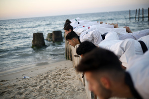 Palestinian youths play and practice taekwondo on the Mediterranean beach during sunset in Khan Yunis, southern Gaza Strip. The "Funoon" taekwondo team trains taekwondo at the Mediterranean beach at sunset, as part of a training program organized by the trainers in the team, as they allocate a day of training on the seashore of Khan Yunis, southern Gaza Strip.
