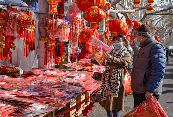 Two customers choose to buy Spring Festival decorations at a New Year market to welcome the arrival of the Chinese Lunar New Year.