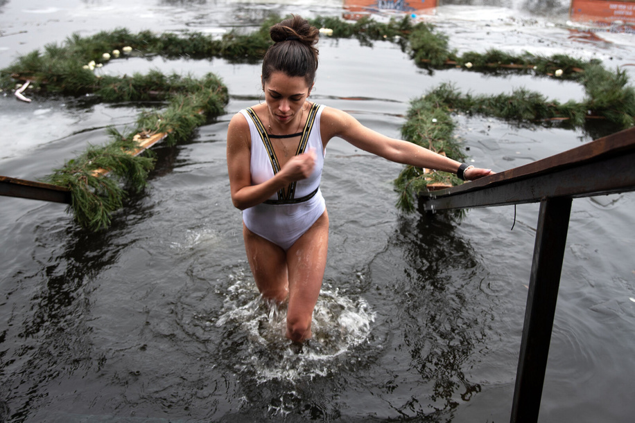 A woman crosses herself after emerging from near-freezing water in a river in Kyiv during the Epiphany. On January 19th, Ukrainian Orthodox Christians celebrated the Epiphany which commemorates the baptism of Jesus in the River Jordan. Believers submerged themselves three times in the icy waters of the Dnieper river to honour the Holy Trinity.