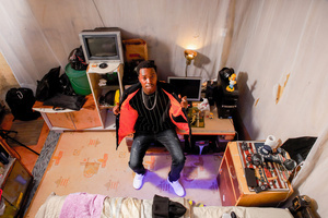 A 22-Year-Old Brian Thomas, dressed in his nice attire, poses inside his decorated house in Kibera. The young Kenyan youths are driven into a competency of having their own homes away from their parents where they, most importantly, learn to tackle life through different challenges. The competition to have the best-decorated rooms filled with different designer outfits is one way of avoiding daily difficulties such as drug abuse, teenage pregnancies, early marriages, and negative judgments from locals. To most young youths having a home is the start of a new life, and it comes with many responsibilities. Unauthorized housing is the most lucrative investment in Kenya today. Therefore for one to have a house with landlords renting rooms to let at Ksh 1,500 ($ 12) to Ksh 5000 ($ 40) a month, that is almost too hard to pay for most youths with low-income jobs and therefore needs an extra effort to raise their sources of income.