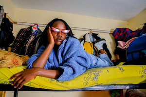 A 20-Year-Old Cynthia Gesare poses on her bed inside her little room surrounded by closet arrangements in Kibera. The young Kenyan youths are driven into a competency of having their own homes away from their parents where they, most importantly, learn to tackle life through different challenges. The competition to have the best-decorated rooms filled with different designer outfits is one way of avoiding daily difficulties such as drug abuse, teenage pregnancies, early marriages, and negative judgments from locals. To most young youths having a home is the start of a new life, and it comes with many responsibilities. Unauthorized housing is the most lucrative investment in Kenya today. Therefore for one to have a house with landlords renting rooms to let at Ksh 1,500 ($ 12) to Ksh 5000 ($ 40) a month, that is almost too hard to pay for most youths with low-income jobs and therefore needs an extra effort to raise their sources of income.