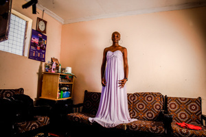 A 23-Year-Old model Risper Atieno poses in her room in the Kibera Slum. The young Kenyan youths are driven into a competency of having their own homes away from their parents where they, most importantly, learn to tackle life through different challenges. The competition to have the best-decorated rooms filled with different designer outfits is one way of avoiding daily difficulties such as drug abuse, teenage pregnancies, early marriages, and negative judgments from locals. To most young youths having a home is the start of a new life, and it comes with many responsibilities. Unauthorized housing is the most lucrative investment in Kenya today. Therefore for one to have a house with landlords renting rooms to let at Ksh 1,500 ($ 12) to Ksh 5000 ($ 40) a month, that is almost too hard to pay for most youths with low-income jobs and therefore needs an extra effort to raise their sources of income.