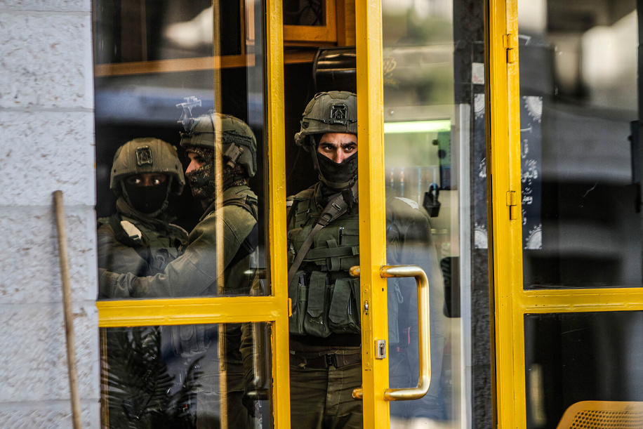 Israeli soldiers searching a shop near the area where three Palestinians were shot in the village of Surra, west of Nablus, in the occupied West Bank. Israeli forces fatally shot the gunmen who opened fire on troops. It was the latest bloodshed in a year-long wave of violence in the region.