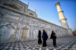 Tourists visit the Taj Mahal in Agra. The Taj Mahal is a mausoleum located in the right bank of the river Yamuna - Agra, India, built by Mughal Emperor Shah Jahan in memory of his favorite wife, Mumtaz. The Taj Mahal is considered the finest example of Mughal architecture, a style that combines elements from Persian, Oman, Indian, and Islamic architectural styles. The Taj Mahal is in the list of modern Seven Wonders of the World and It has also been a protected UNESCO World Heritage Site since 1983.