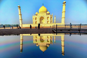 Tourists visit the Taj Mahal in Agra. The Taj Mahal is a mausoleum located in the right bank of the river Yamuna - Agra, India, built by Mughal Emperor Shah Jahan in memory of his favorite wife, Mumtaz. The Taj Mahal is considered the finest example of Mughal architecture, a style that combines elements from Persian, Oman, Indian, and Islamic architectural styles. The Taj Mahal is in the list of modern Seven Wonders of the World and It has also been a protected UNESCO World Heritage Site since 1983.
