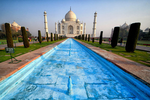 A view of The Taj Mahal. The Taj Mahal is a mausoleum located in the right bank of the river Yamuna - Agra, India, built by Mughal Emperor Shah Jahan in memory of his favorite wife, Mumtaz. The Taj Mahal is considered the finest example of Mughal architecture, a style that combines elements from Persian, Oman, Indian, and Islamic architectural styles. The Taj Mahal is in the list of modern Seven Wonders of the World and It has also been a protected UNESCO World Heritage Site since 1983.