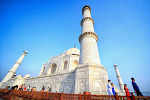 Tourists visit the Taj Mahal in Agra. The Taj Mahal is a mausoleum located in the right bank of the river Yamuna - Agra, India, built by Mughal Emperor Shah Jahan in memory of his favorite wife, Mumtaz. The Taj Mahal is considered the finest example of Mughal architecture, a style that combines elements from Persian, Oman, Indian, and Islamic architectural styles. The Taj Mahal is in the list of modern Seven Wonders of the World and It has also been a protected UNESCO World Heritage Site since 1983.