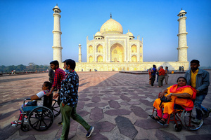 Tourists visit the Taj Mahal in Agra. The Taj Mahal is a mausoleum located in the right bank of the river Yamuna - Agra, India, built by Mughal Emperor Shah Jahan in memory of his favorite wife, Mumtaz. The Taj Mahal is considered the finest example of Mughal architecture, a style that combines elements from Persian, Oman, Indian, and Islamic architectural styles. The Taj Mahal is in the list of modern Seven Wonders of the World and It has also been a protected UNESCO World Heritage Site since 1983.