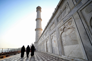 Tourists visit the Taj Mahal in Agra. The Taj Mahal is a mausoleum located in the right bank of the river Yamuna - Agra, India, built by Mughal Emperor Shah Jahan in memory of his favorite wife, Mumtaz. The Taj Mahal is considered the finest example of Mughal architecture, a style that combines elements from Persian, Oman, Indian, and Islamic architectural styles. The Taj Mahal is in the list of modern Seven Wonders of the World and It has also been a protected UNESCO World Heritage Site since 1983.