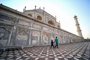 Young brothers visit the Taj Mahal in Agra. The Taj Mahal is a mausoleum located in the right bank of the river Yamuna - Agra, India, built by Mughal Emperor Shah Jahan in memory of his favorite wife, Mumtaz. The Taj Mahal is considered the finest example of Mughal architecture, a style that combines elements from Persian, Oman, Indian, and Islamic architectural styles. The Taj Mahal is in the list of modern Seven Wonders of the World and It has also been a protected UNESCO World Heritage Site since 1983.