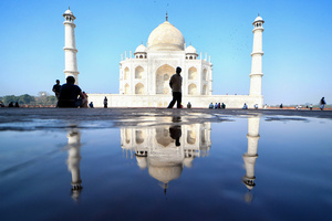 Tourists visit the Taj Mahal in Agra. The Taj Mahal is a mausoleum located in the right bank of the river Yamuna - Agra, India, built by Mughal Emperor Shah Jahan in memory of his favorite wife, Mumtaz. The Taj Mahal is considered the finest example of Mughal architecture, a style that combines elements from Persian, Oman, Indian, and Islamic architectural styles. The Taj Mahal is in the list of modern Seven Wonders of the World and It has also been a protected UNESCO World Heritage Site since 1983.
