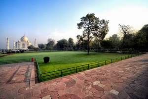 A view of The Taj Mahal. The Taj Mahal is a mausoleum located in the right bank of the river Yamuna - Agra, India, built by Mughal Emperor Shah Jahan in memory of his favorite wife, Mumtaz. The Taj Mahal is considered the finest example of Mughal architecture, a style that combines elements from Persian, Oman, Indian, and Islamic architectural styles. The Taj Mahal is in the list of modern Seven Wonders of the World and It has also been a protected UNESCO World Heritage Site since 1983.
