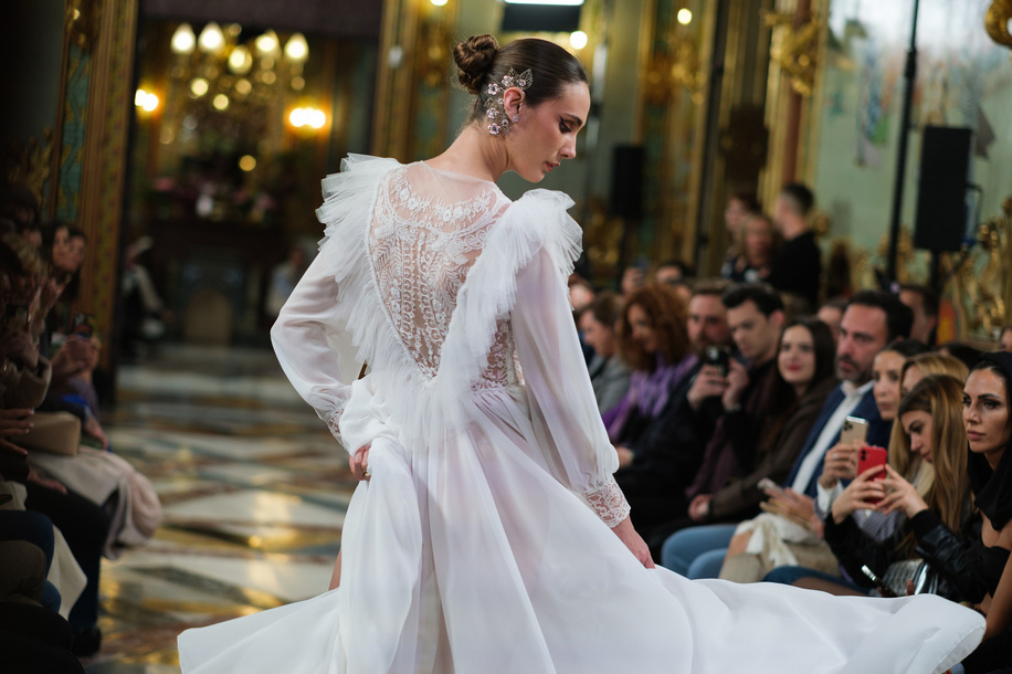 A model showcases creations by Lucia Cano during the Atelier Couture bridal catwalk within Madrid Fashion Week, at Santa Isabel Palace in Madrid.