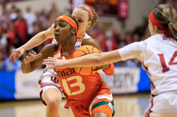 Indiana Hoosiers guard Grace Berger (34) and Sara Scalia (14) play against Miami Hurricanes guard Lashae Dwyer (13) during the second round NCAA women's basketball tournament game at Simon Skjodt Assembly Hall. The Hoosiers lost to the Hurricanes 70-68.