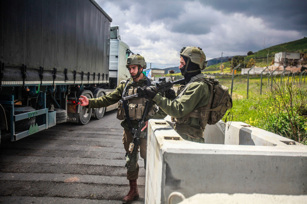 Israeli soldiers stand guard at a new military outpost that has been placed near the town of Hawara, south of Nablus in the West Bank.