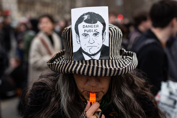 A placard with a Macron's figure that says "Danger Public" is seen in a woman's hat during the demonstration. Hundreds of people gathered in Place Vauban, in Paris, for another wave of protests after French President Emmanuel Macron forced the reform of pensions using Subsection 3 (Article 49.3) of the French Constitution. Article 49.3 allows the government to force passage of a bill without a vote unless the parliament votes to censure with a motion of no confidence.