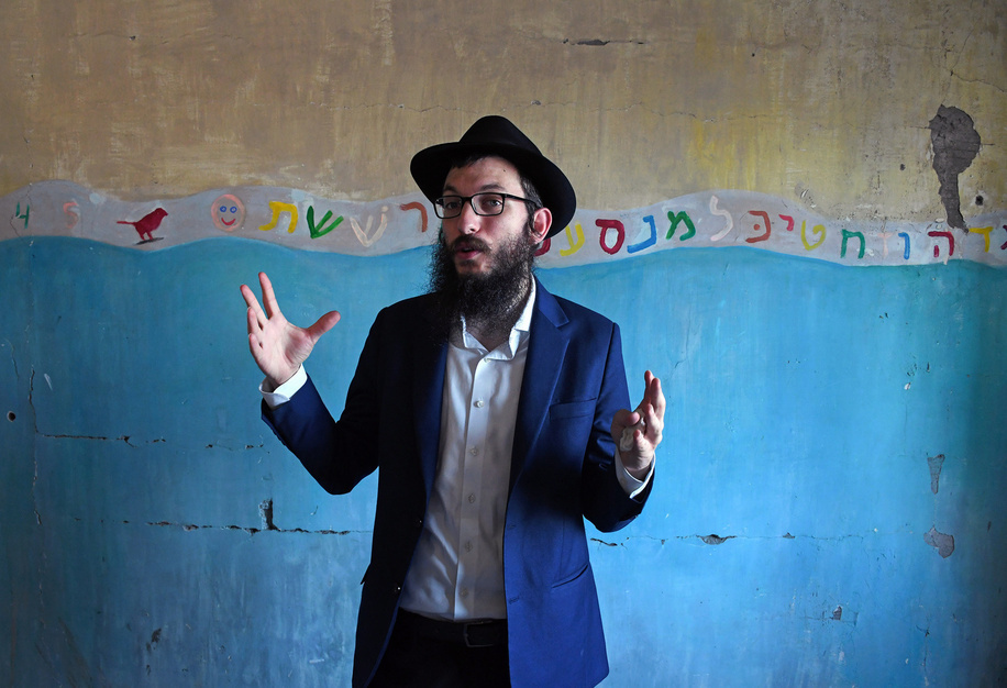 Rabbi Israel Kozlovsky, Director of Nariman Lighthouse (Chabad) makes gestures inside the bedroom of baby Moshe Holtzberg with Hebrew letter drawings behind him inside the Jewish community centre during a guided tour for the media. The guided tour will begin with a visit to the living memorial created on the terrace commemorating the memory of all those who lost their lives in Mumbai on November 26, 2008. The tour then moves onto the 5th floor where the Rabbi and his family lived. Lastly, a visit to the carefully preserved 4th floor where the terrorist held hostages and engaged in combat with NSG (National Security Guard) Commandos where every surface is inundated with lasting marks left by bullets and grenades. A walking tour will be held every Sunday starting May 21 at 5 pm.