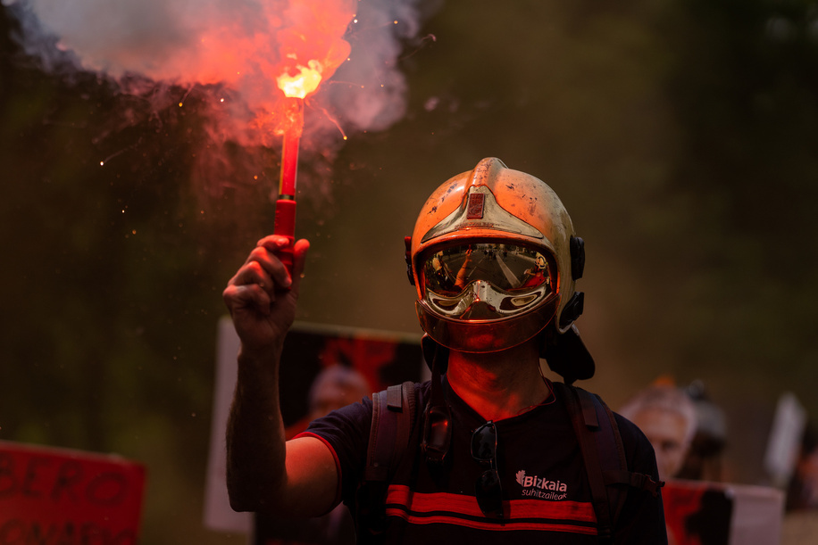 A Firefighters holds a flare during the demonstration. Demonstration of Spanish firefighters organized by the Professional Firefighters Union (CUBP). The firefighters were calling for a national, legal framework for fire services that would regulate employment and working conditions.There are currently many autonomous communities that do not have laws that regulate their activity, leaving them unprotected.