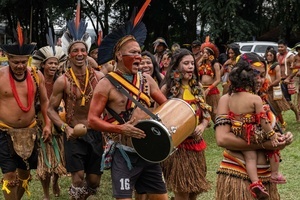 A group of indigenous people wearing ornaments dances and sings during the celebrations of the Indigenous People’s Day, at the Aldeia Katurãma.