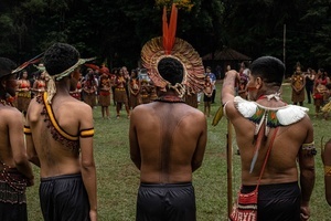 Indigenous people watch a ceremony during the celebrations of the Indigenous Peoples Day, at the Aldeia Katurãma.