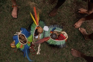 The head ornaments (cocar) and music instruments seen laying on the grass during the celebrations of the Indigenous People’s Day, at the Aldeia Katurãma.