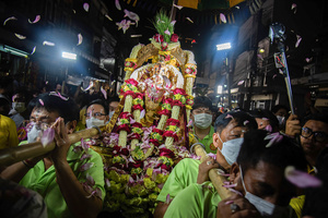Hindu devotees carry a statue of Hindu god Lord Ganesha for worship during a ceremony to mark the Ganesh Chaturthi festival at Wat Khaek in Bangkok. The Ganesh Chaturthi is a Hindu festival to commemorate the birth of the Hindu god Lord Ganesha.
